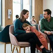 Supportive family counseling session in a waiting room setting.
